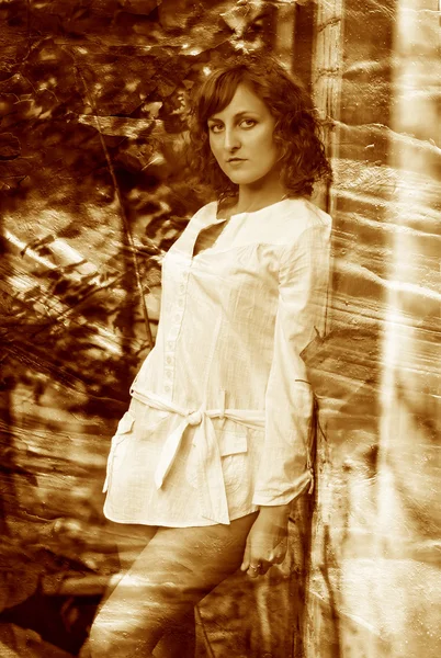 Retro sepia photo curly-haired girl with bare legs in white shir — Stock Photo, Image