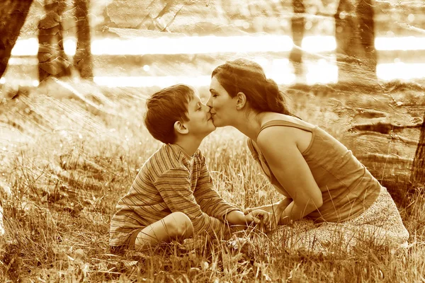 Retro sepia photo, Mom son of woman and child sitting on gra — Stock Photo, Image