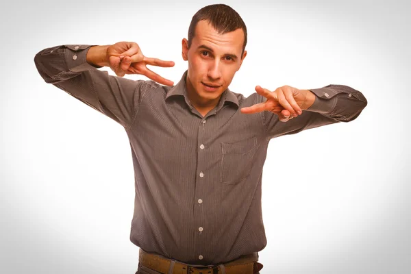 Brunette man shows sign hippie freedom and peace, a symbol of vi Stock Image