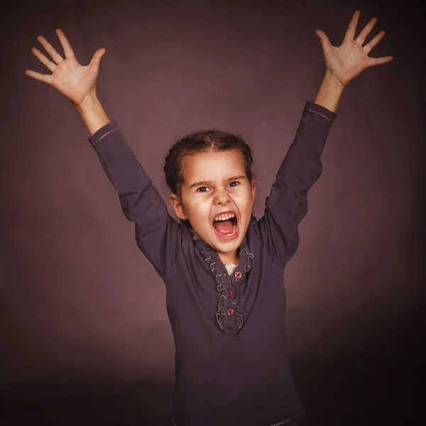 Little child girl opened her mouth screaming lifted up — Stock Photo, Image