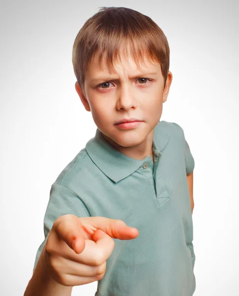 Kid angry boy shows his finger to screen evil is isolated on a w — Stock Photo, Image
