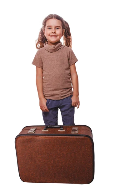Brunette girl smiling child standing next to suitcase for travel — Stock Photo, Image