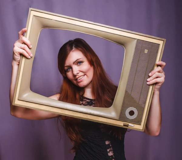 Teen girl child framed television smiling on gray — Stock Photo, Image