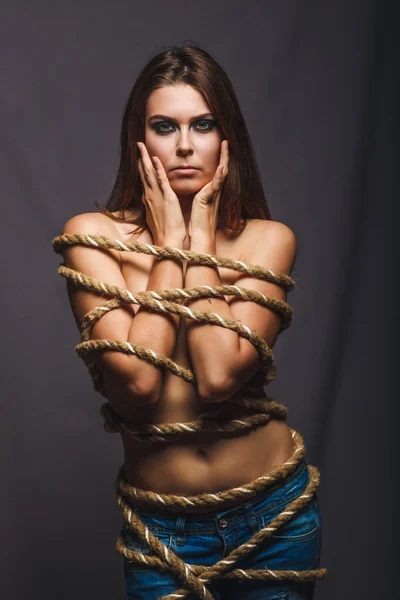 Brunette hostage, captive bound woman with rope prisoner in jean — Stock Photo, Image