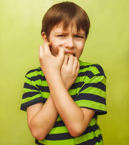 Young kid child boy toothache pain in mouth, dental pain, holdin