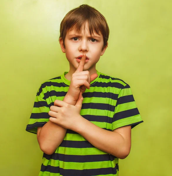 Young boy kid shows sign hand gesture finger to lips mouth shh s — Stock Photo, Image