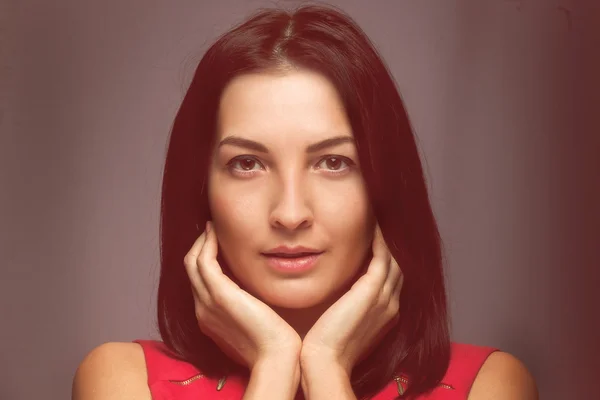 Close portrait of girl brunette woman on a black background — Stock Photo, Image