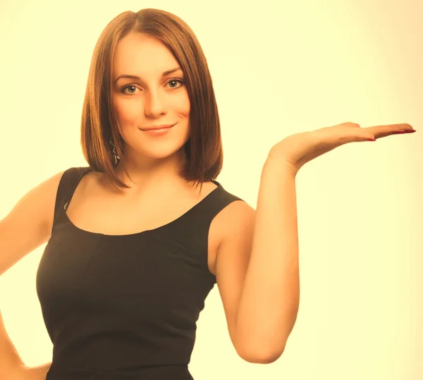 Portrait happy young blond woman showing open hand holding in a — Stock Photo, Image