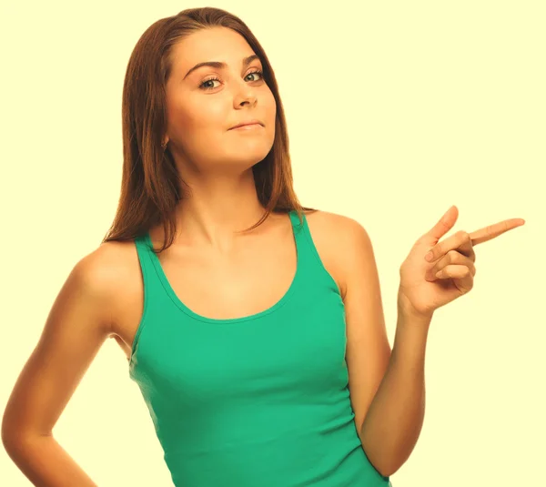 Surprised woman shows finger in direction hand isolated white ba — Stock Photo, Image