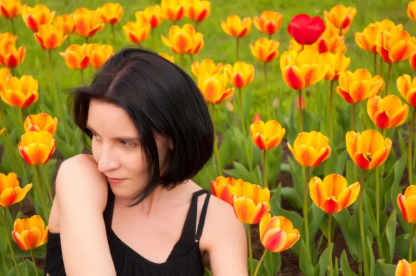 Young girl and tulips — Stock Photo, Image