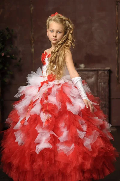 Blonde girl in a smart white with a red dress — Stock Photo, Image