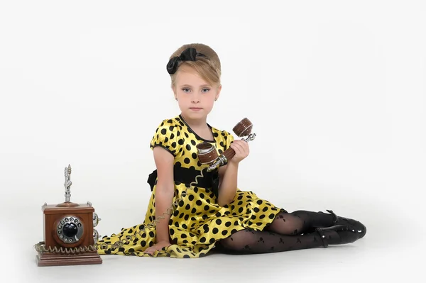 Little girl with a retro phone — Stock Photo, Image