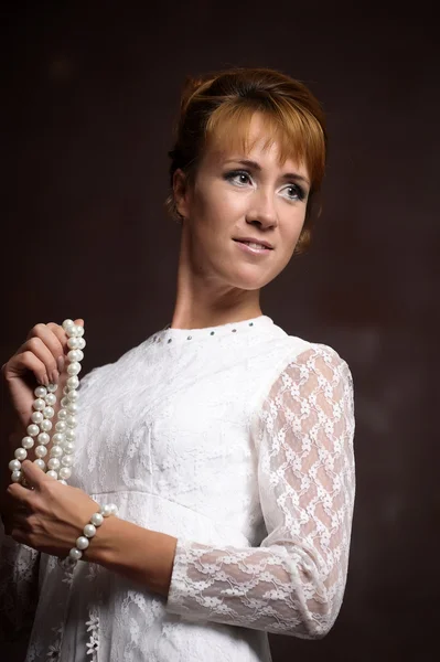 Young woman in white dress in interior — Stock Photo, Image