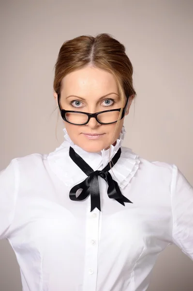 Frau in weißer Bluse mit Schleife und Brille — Stockfoto