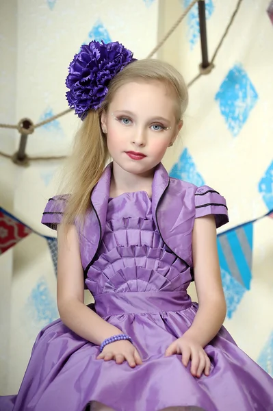 Beautiful teenager in purple dress — Stock Photo, Image