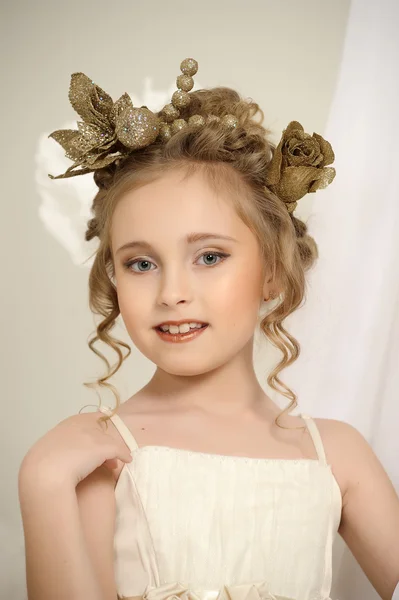 Portrait of a girl with a golden wreath on head — Stock Photo, Image