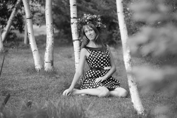 Woman wearing a crown of flowers next to a birch — Stock Photo, Image