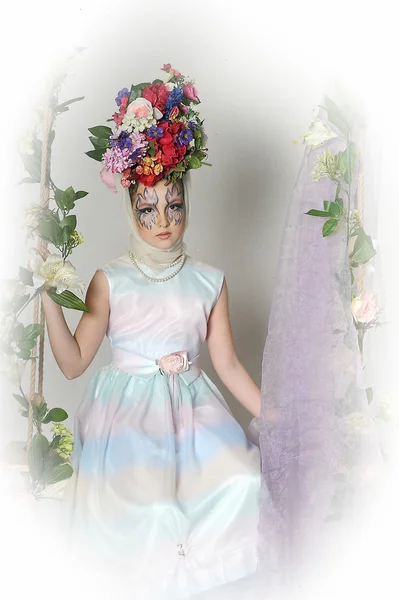 Portrait of a beautiful girl with flowers on her head — Stock Photo, Image