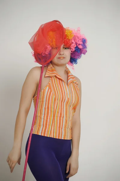 Girl with balloons in a colored wig — Stock Photo, Image
