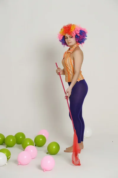 Girl with balloons in a colored wig — Stock Photo, Image