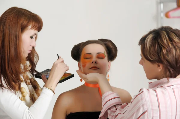 Maquiagem artistas preparar o modelo para uma sessão de fotos — Fotografia de Stock
