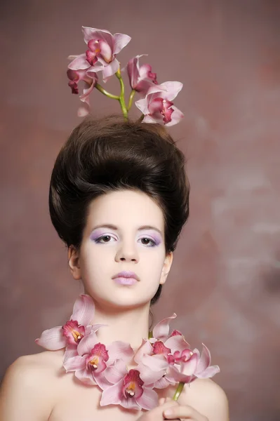 Retrato de menina encantadora com orquídeas — Fotografia de Stock