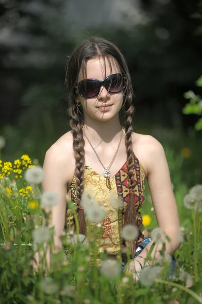 Beautiful girl in dandelions — Stock Photo, Image