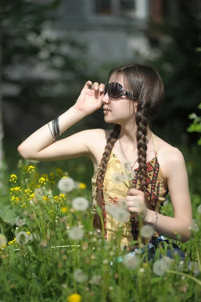 Beautiful girl in dandelions — Stock Photo, Image