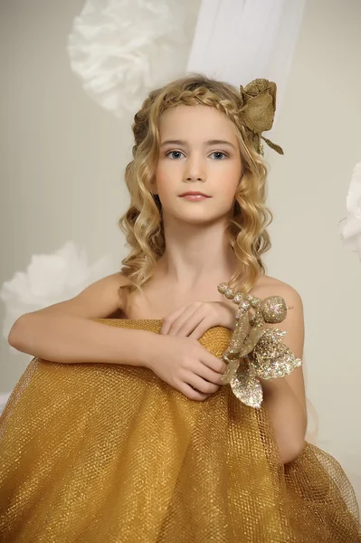 Portrait of a beautiful girl in a gold dress — Stock Photo, Image