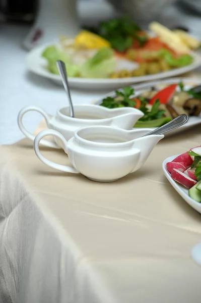 Sauce bowls and salad in the background — Stock Photo, Image