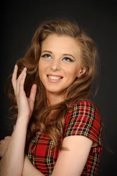 Beautiful girl in a checkered dress — Stock Photo, Image