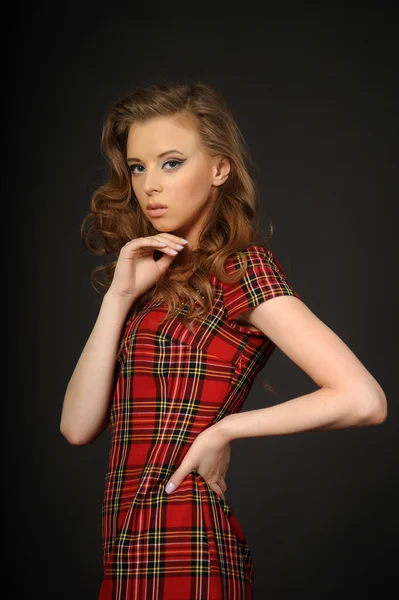 Girl in a checkered dress — Stock Photo, Image