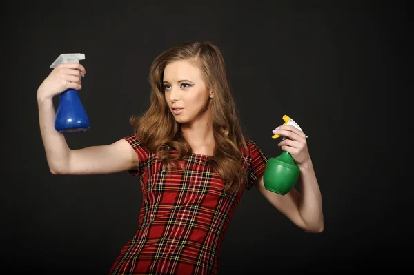 Woman and plastic spray bottles — Stock Photo, Image