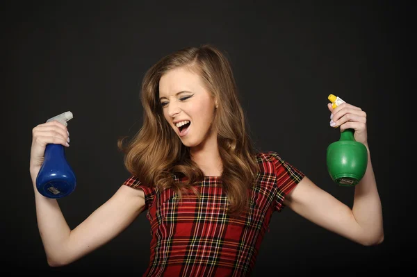 Woman and plastic spray bottles — Stock Photo, Image