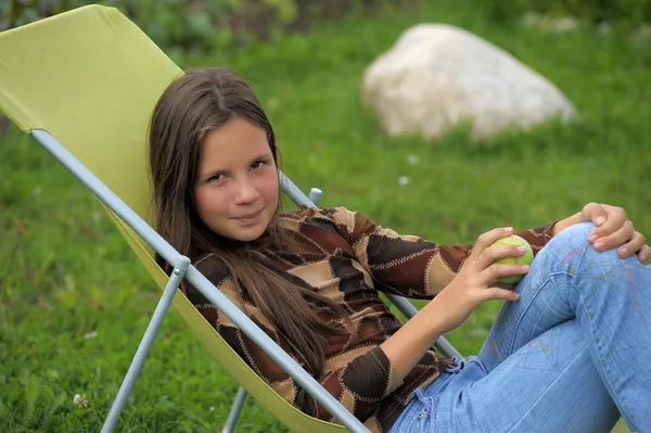 Funny girl with apple outdoors — Stock Photo, Image