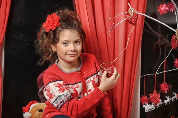 Portrait of a young girl in a red sweater — Stock Photo, Image