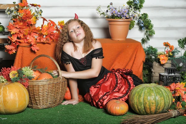 Evil red-haired girl with pumpkin — Stock Photo, Image