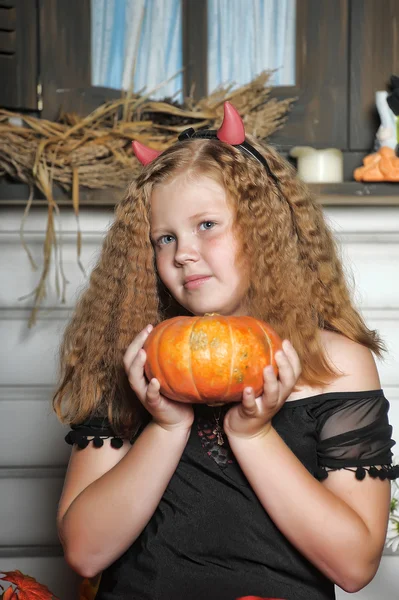 Evil red-haired girl with pumpkin — Stock Photo, Image