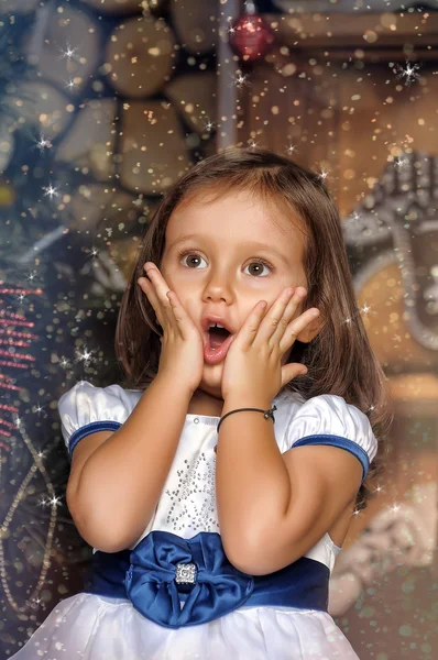 Surprised girl near the Christmas tree — Stock Photo, Image