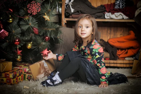 Niña con regalos cerca de un árbol de Navidad — Foto de Stock