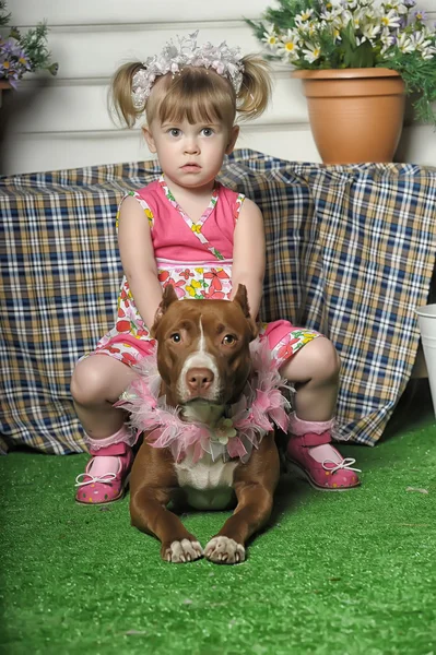Girl sitting on dog — Stock Photo, Image