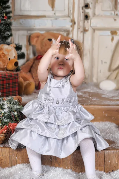 Girl throwing fake snow — Stock Photo, Image