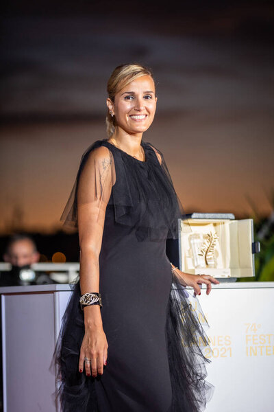 CANNES, FRANCE - JULY 17, 2021: Julia Ducournau poses with the Palme d'Or 'Best Movie Award' for 'Titane' during the 74th annual Cannes Film Festival 