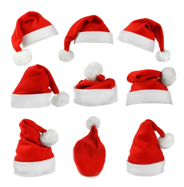 Sada červených santa claus klobouky izolovaných na bílém pozadí — Stock fotografie