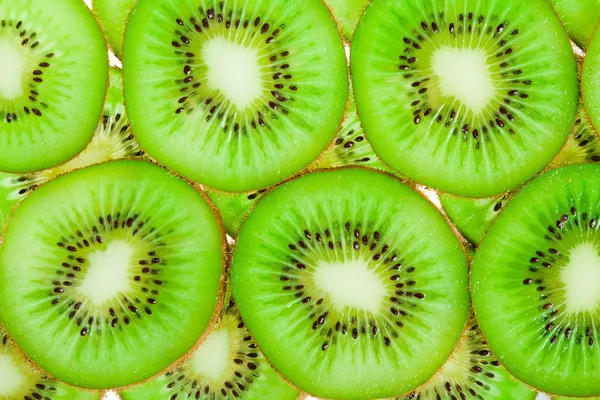 Närbild bakgrund av grön kiwi skivor — Stockfoto