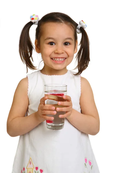 Smiling little girl with a glass of water on a white background — Stock Photo, Image