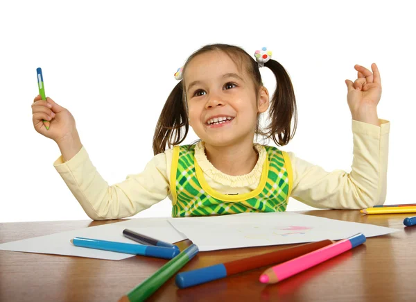 Little girl with a pencil next to a white background Stock Image