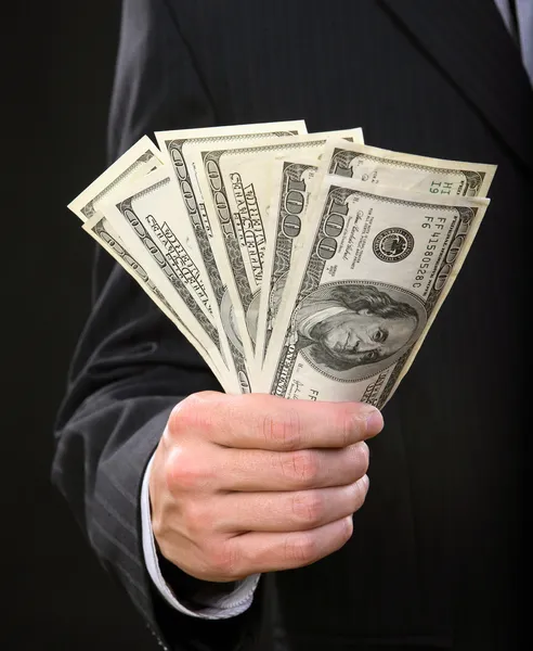 Zakenman aanhouden van geld in zijn hand — Stockfoto
