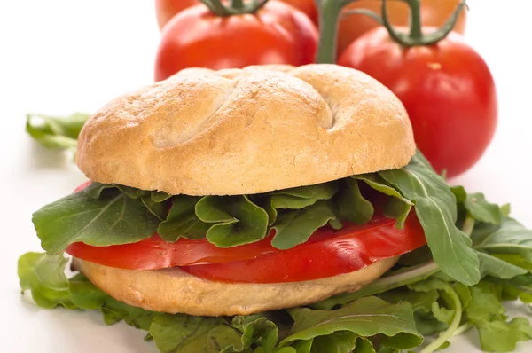 Sandwich with tomatoes and arugula — Stock Photo, Image