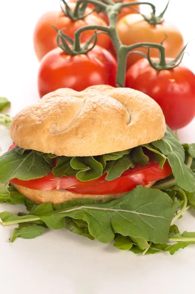 Sandwich with tomatoes and arugula — Stock Photo, Image